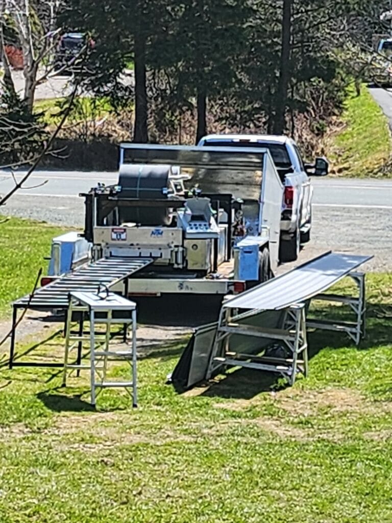 Freedom Metal Roofing mobile metal panel machine operating at a residential site in NL