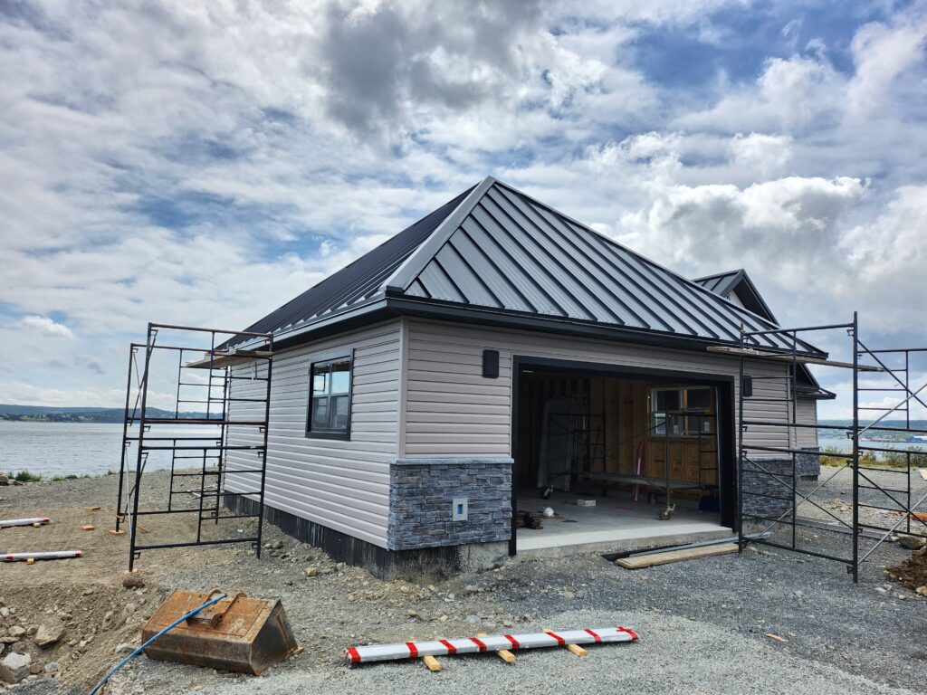 Black steel hip roof on garage installed by Freedom Metal Roofing NL
