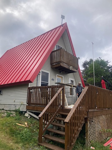 Red steel  A-Frame roof installed on a residential house by Freedom Metal Roofing NL