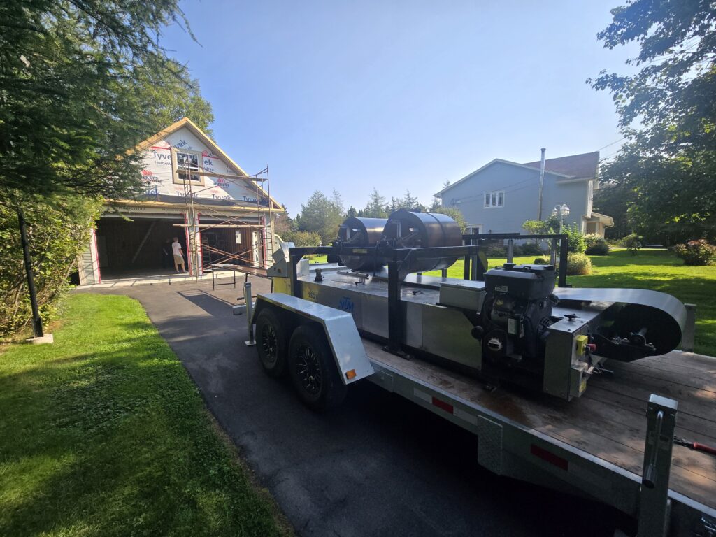 Freedom Metal Roofing mobile metal roofing unit set up at a residential construction site in NL