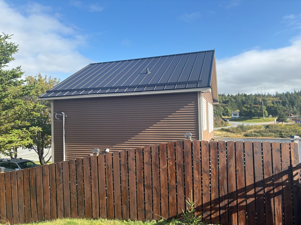 Home with steel roofing completed by Freedom Metal Roofing NL, highlighted in satisfied customer testimonial

