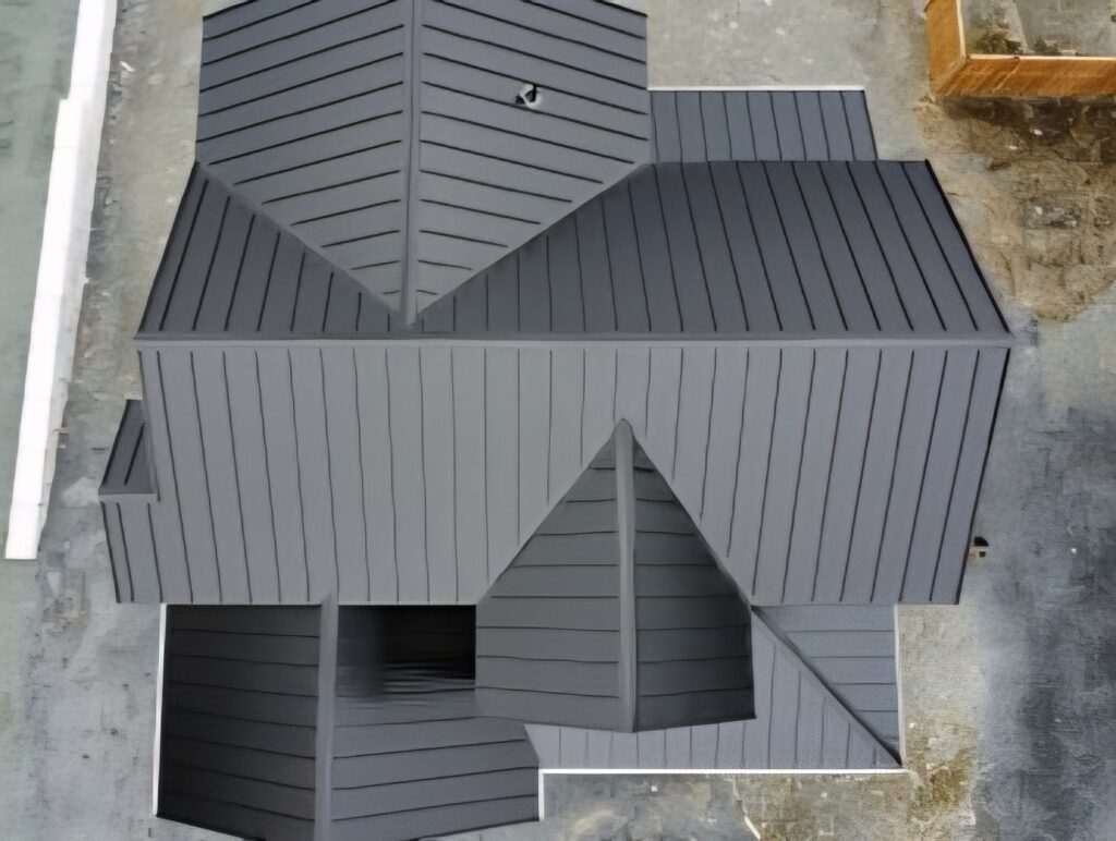 Top-down aerial view of completed metal roofing system on house