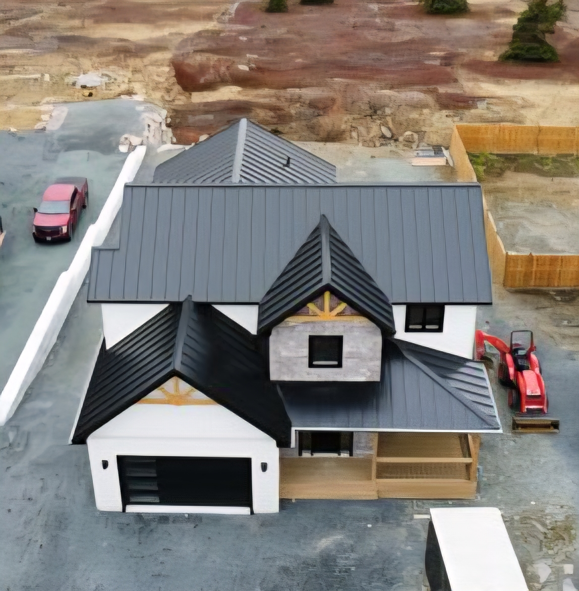 Aerial front view of completed metal roof installation on residential home in NL by Freedom Metal Roofing